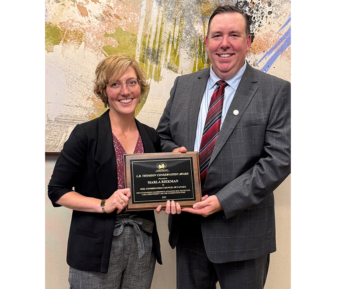 Alan Kruszel, CCA and Eastern Producer Director with the Soil Conservation Council of Canada, presents CCA Marla Riekman with the L.B. Thomson Conservation Award during the Soils for Our Future conference in Winnipeg, MB, Canada, July 20–25, 2025. Riekman is a Soil Management Specialist with Manitoba Agriculture’s Ag Resource Branch.