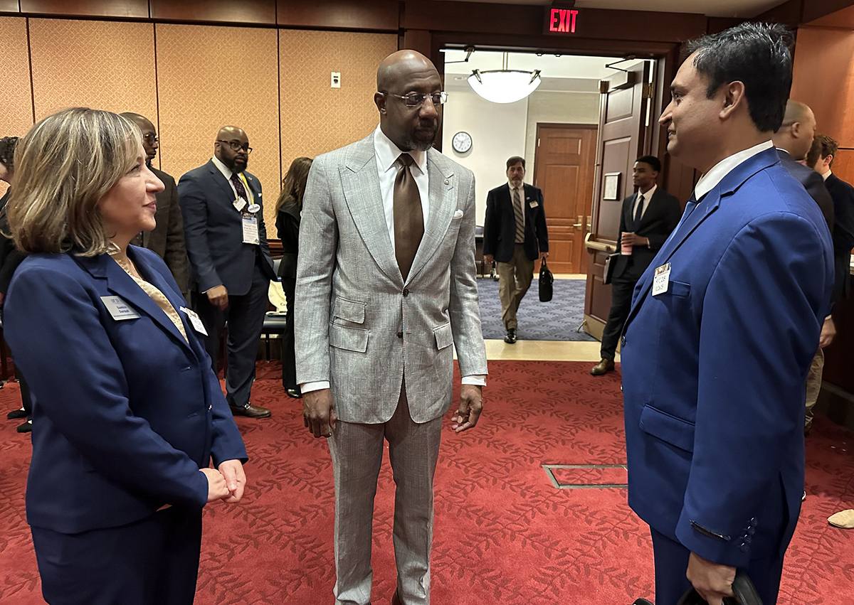 Congressional Visits Day participants Samira Daroub and Somashekhar Punnuri speak with Georgia Sen. Raphael Warnock