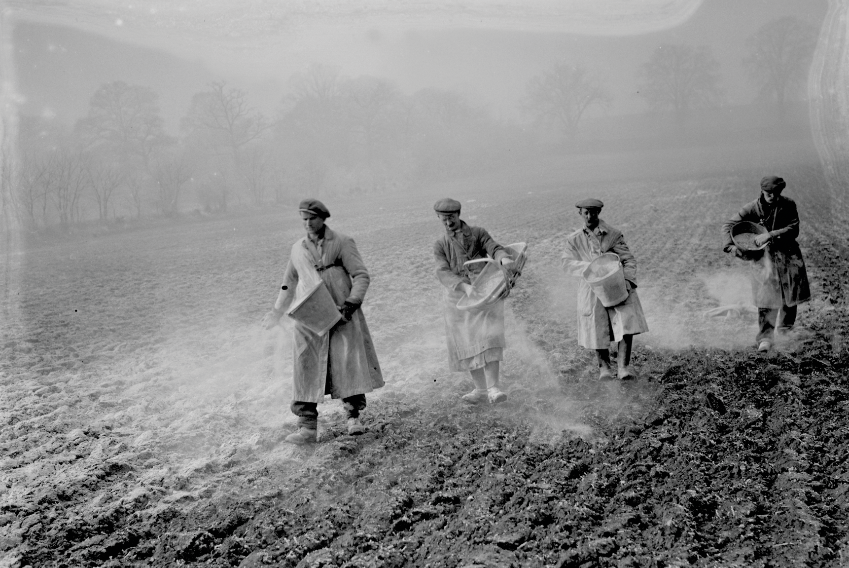 Farm workers spreading bone fertilizer on fields in 1936. Photo courtesy of Alamy Stock Photo/Smith Archive.