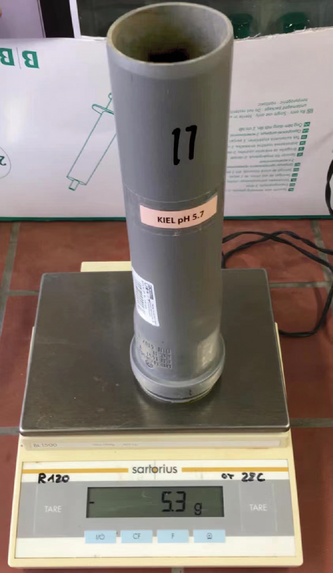 Weighing a soil column. Photo by Xinyue Cao.