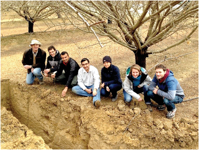 University of California–Davis professor Jan Hopmans (far left), lead author on the retrospective article, with students and postdocs in an almond orchard exploring how the tree roots extract soil water and nutrients. Photo courtesy of Jan Hopmans.