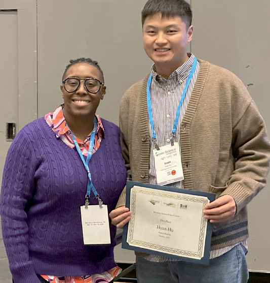 Tiffany Carter (Vice-Chair DEI Committee) presents Huan Hu (China Agricultural University) with a certificate for finishing first in the 2023 contest.