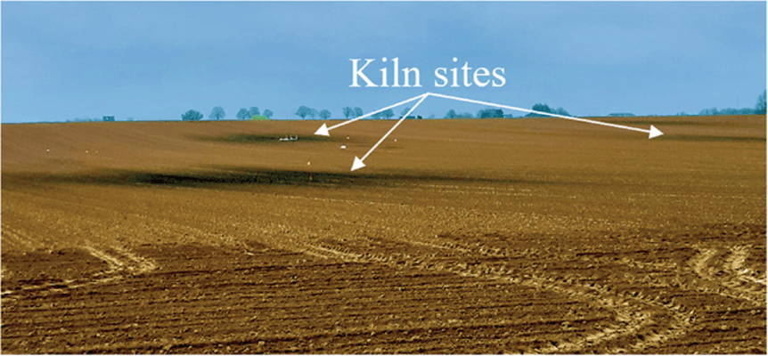 Century-old kiln sites are visible as darker oval spots on a bare soil. Image courtesy of Martin Zanutel (UCLouvain).