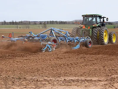 With non-inversion shallow (vertical) tillage, the implements till less deeply than the plow, mixing the top 6 to 8 inches of soil rather than inverting it. Photo is courtesy of the Prince Edward Island Potato Board.