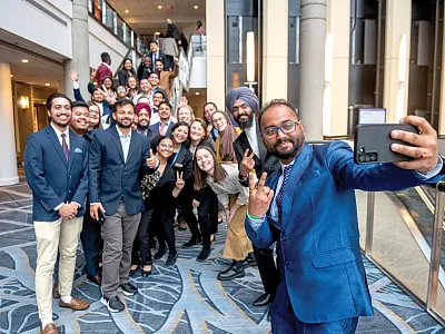 Graduate students pose for a picture at the 2022 ASA, CSSA, and SSSA Annual Meeting. Taking the picture in the foreground is 2022 travel scholarship recipient Jyoti Prasad Kakati. Photo by Remsberg.