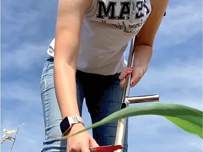 Ohio State University Extension Associate and CCA Rachel Cochran cleans out her soil probe between soil samples.