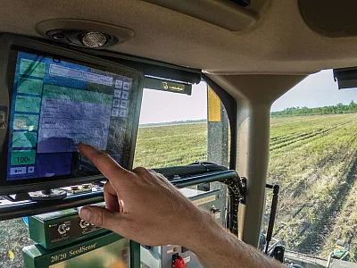 A farmer in a tractor/planter equipped with a planter monitor, a precision agriculture tool, to guide seed planting. Photo by Lance Cheung, USDA.