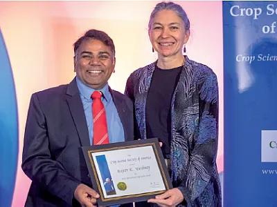 Awards elevate and recognize the contributions of our members. Here 2022 CSSA President Marilyn Warburton (right) presents Rajev Varshney with the CSSA 2022 International Crop Science Award.