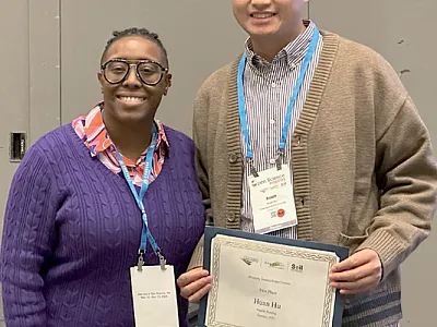 Tiffany Carter (Vice-Chair DEI Committee) presents Huan Hu (China Agricultural University) with a certificate for finishing first in the 2023 contest.