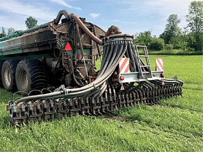 Left: Sarah Brickman, a master’s student at the University of Vermont, injects a greenhouse gas sample into a glass vial at Borderview Research Farm in Alburgh, VT. Photo by Karin Rand. Right: A  Veenhuis Euroject 1200 grassland injector applies manure to a subplot at the farm. Photo by Sarah Brickman.