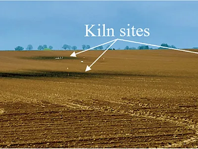 Century-old kiln sites are visible as darker oval spots on a bare soil. Image courtesy of Martin Zanutel (UCLouvain).
