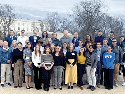 Congressional Visits Day attendees pose for a group photo near the U.S. Capitol. They represented 23 states and conducted 63 meetings with congressional offices.