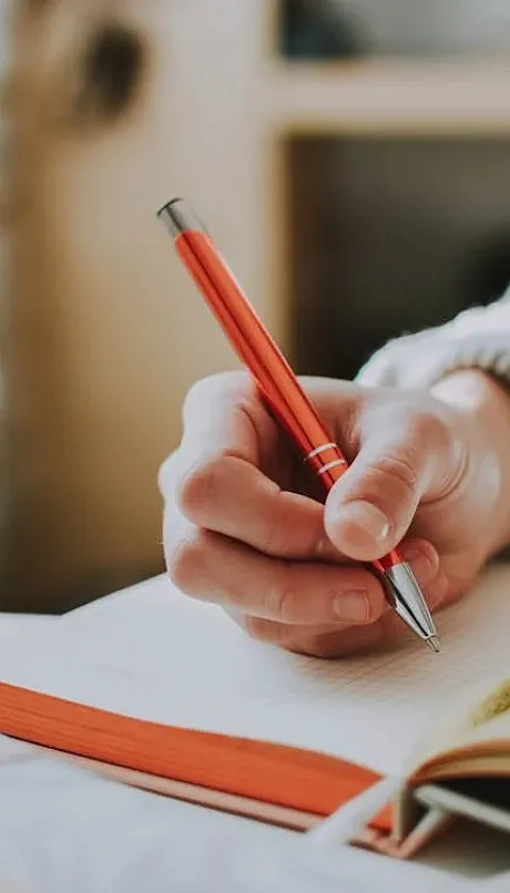 Someone writing in a journal