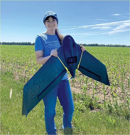 South Dakota State University graduate student Skye Brugler poses with a multispectral drone, which can be used in precision agriculture to capture imaging data and monitor plant health, productivity, stress, growth, disease, and other qualities. Photo by Deepak Joshi.