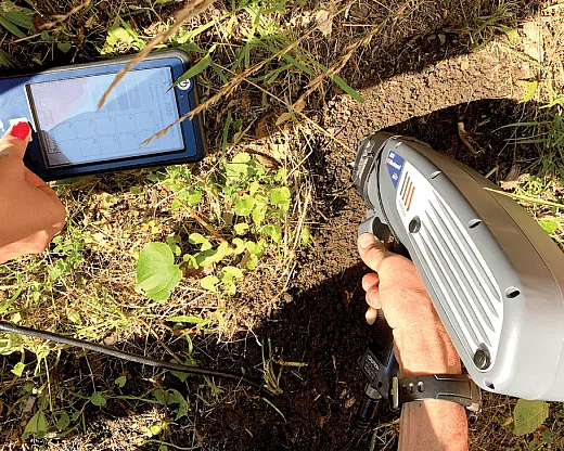 Using a handheld X-ray fluorescence (XRF) analyzer for in-field soil lead testing. Photo courtesy of Anna Paltseva.