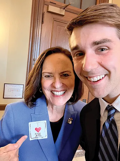 Sen. Deb Fischer, R-NE, gestures to a sticker she received from the Congressional Visits Day delegation, including Eli Halverson, a graduate research assistant at South Dakota State University.