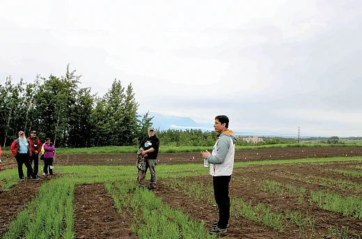 University of Alaska Fairbanks plant geneticist Jakir Hasan shares an overview of his small-grain breeding research and field trials at the Matanuska Experiment Farm and Extension Center in Palmer, AK to a group of visiting scientists and collaborators from USDA-ARS stations in North Dakota and Washington.