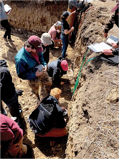 Group judging event: Several teams describe separate profiles in the large soil pits. For the Hokies, in the center of the pit, top to bottom: Rachel Parmele (red hat, kneeling), Elizabeth Eroshenko (bucket hat), Matthew Smith, and Joe Paterson (kneeling). Above them recording their answers are Will Ubben and Sinclair Anderson. Photo by John Galbraith.